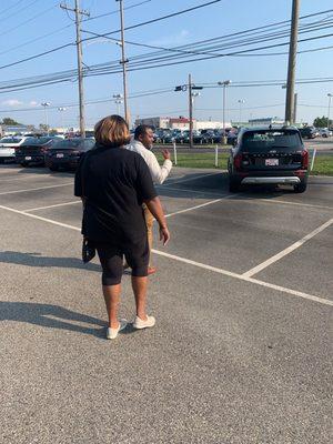 Mom walking to take a glance at the vehicle