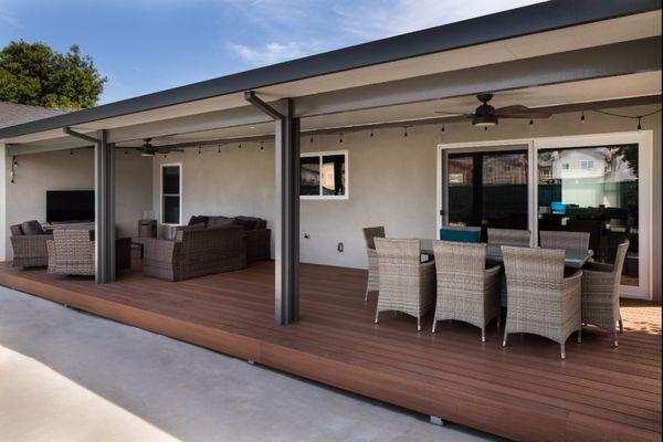 Outdoors living area construction. Recycled bamboo deck with insulated patio cover above.