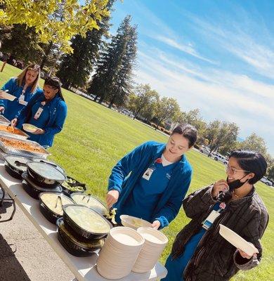 Students celebrate lunch on the lawn.