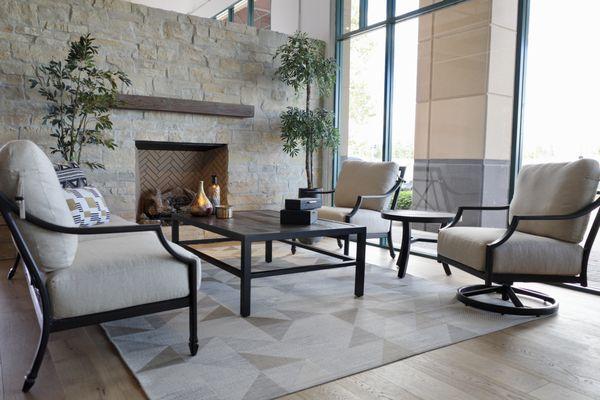 Lancaster from Castelle Patio Furniture set with swivel deep seating in front of an Urbana outdoor Fireplace in our new Pleasanton Showroom