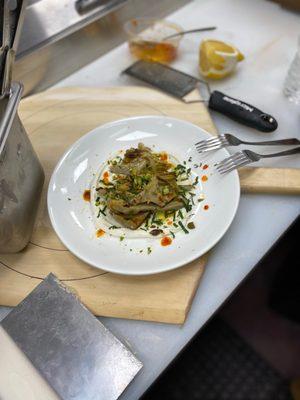 Grilled Artichoke Hearts with mint, whipped Ricotta, Calabrian chili, pistachio