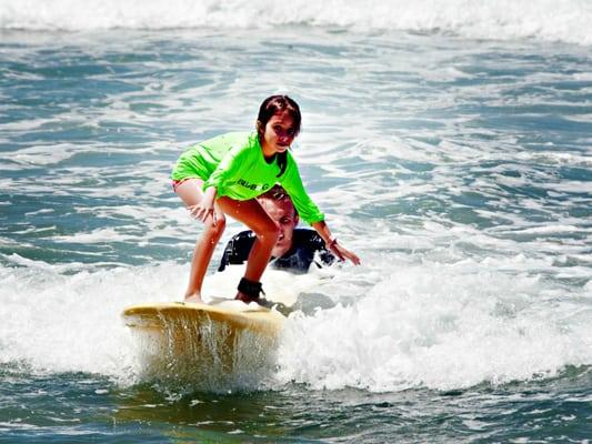 Learning to surf at Aloha Beach Camp.