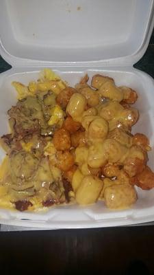 Scrambled, eggs, cheese, pastrami, cheese and tater tots with cheese