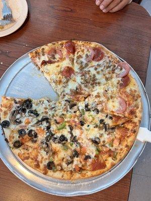 One slice missing of our small half/half pizza