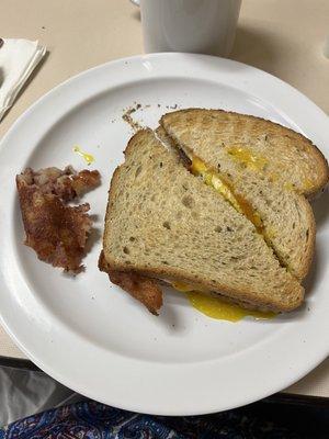 Fried egg sandwich with cheese and bacon