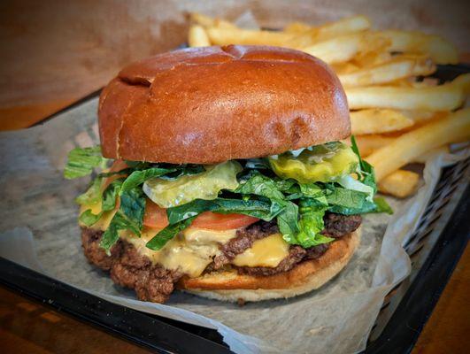 Smash Patty - Quarter lb patty, american cheese, shrettuce, tomato, onion, 1,000 island, griddled brioche bun.