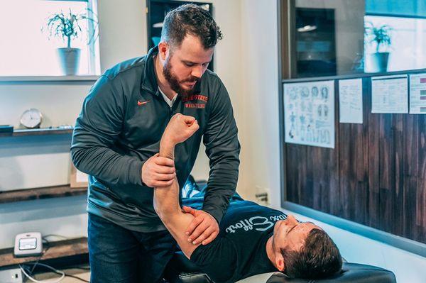 Dr. Kelly manual muscle testing an injured shoulder. Proper assessment directs our care.