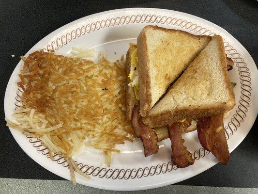 Bacon Breakfast sandwich with side of crispy hash browns