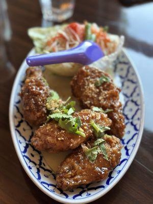 Thai fried chicken served with papaya salad