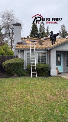 Team members repairing a roof