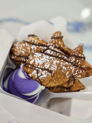 Taiyaki with Ube and milk swirled ice cream with Nutella drizzle and powdered sugar.