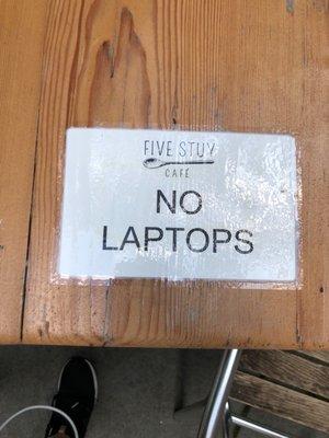 "No laptop" sign on all the tables