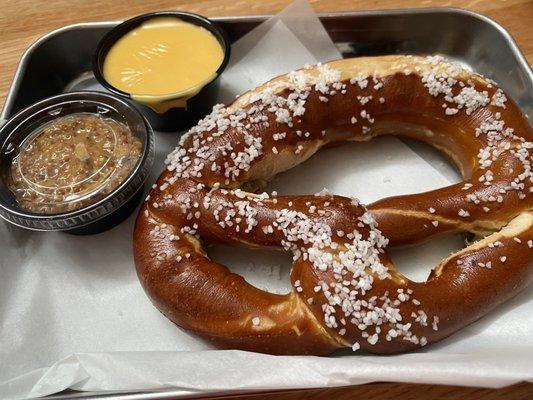 Pretzel with cheese sauce and mustard