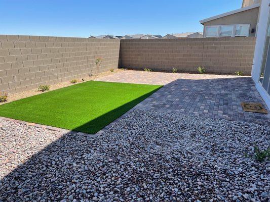 Backyard - turf and plants around wall