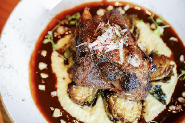 Spur's Snake River Farms Pork Shank features an apple brandy braised kurobuta pork.