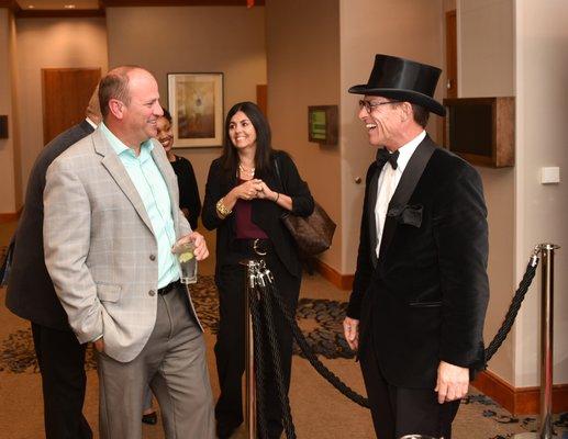 Greeting guests as they enter the theater.