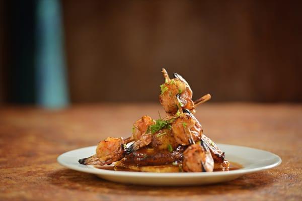 Shrimp Alambres sugar cane  skewers served on our own masa cake with tamarind glaze.