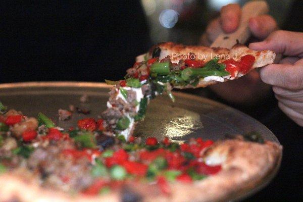 Slice of Rustica Pizza ($32.75 large) - broccoli rabe, sausage, fresh mozzarella, roasted red peppers, parmigiano, olive oil