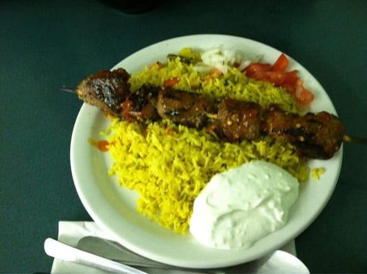 Grilled lamb kabob dinner with yellow, spiced rice w/ veggies and tzatziki sauce