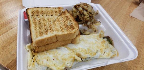 Egg white omelette with bacon, mushrooms and cheese. Potatoes and toast.