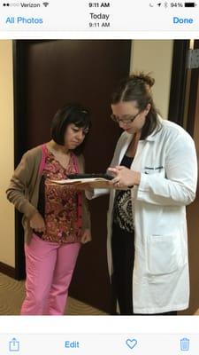 Ms. Lambert confers with Helen a medical assistant regarding patient care