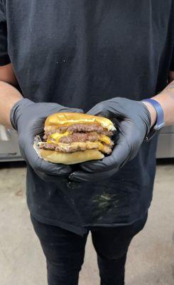 Triple cheeseburger on warm potato bun