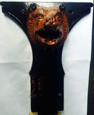 Custom bottle opener with Bear head installed on an old metal tractor part found in a scrap bin at an antique shop for 2 bucks.