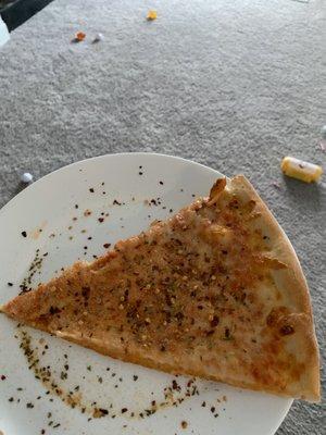 Cheese pizza with oregano, red pepper flakes, garlic.