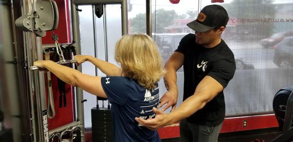 One of our personal trainers cueing the proper form during an exercise.