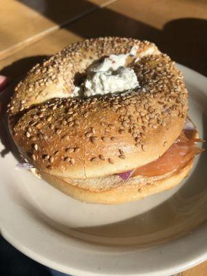 sesame bagel salmon cream cheese and onions