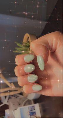 sage green nails with squiggle decoration