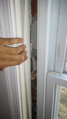 This is the gap between the window and house.  You can see there is no insulation what-so-ever between the window and wall.