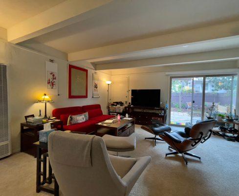 Townhouse living room looking out onto outdoor enclosed patio