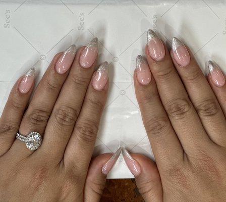 Almond shape, gel pink base with silver French tips with Ni