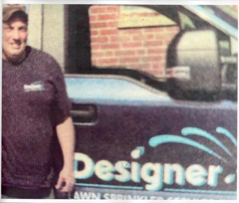 DESIGNER LAWN SPRINKLER SERVICE = SERVICE WITH A SMILE