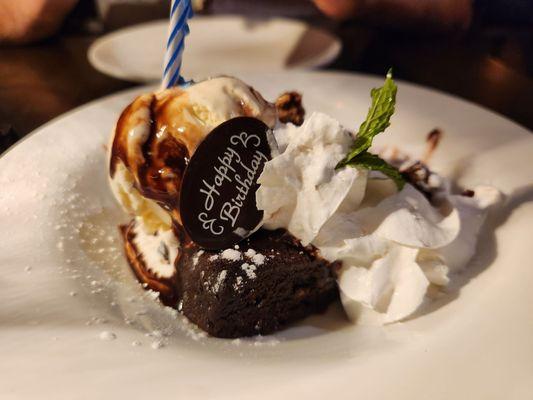 Brownie with peanut butter chunks and vanilla ice cream.