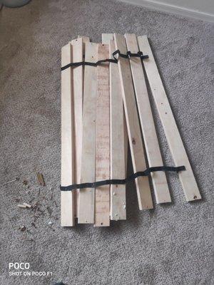 Flimsy wooden slacks for bed that are broken and help together by flimsy fabric