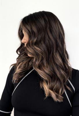 Frace-framing warm highlights to match a face-framing haircut and texturized layers for movement, and reduced heaviness.