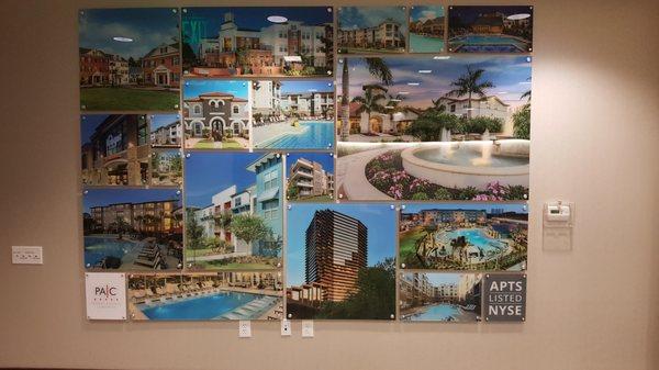 A custom property display wall of images applied to the backside of acrylic mounted with standoffs.