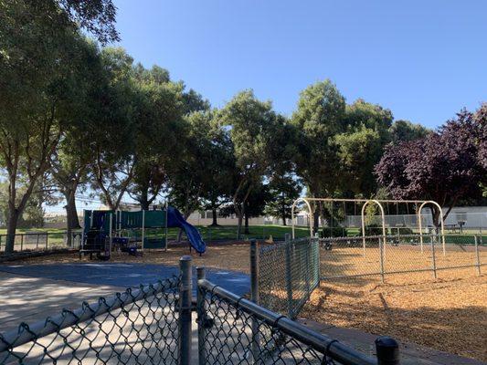 Little kids playground w/ a seasaw! Notice the entry has a gate you can close. There is another gate on the opposite side as well.