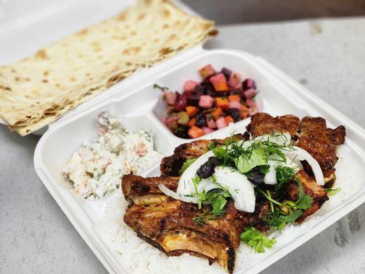 Baby back ribs with rice, vinaigrette and olivia salad.