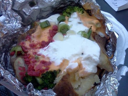 Baked potato with sour cream, cheese, green onions and chives, broccoli, and bacon bites all for less than $6!