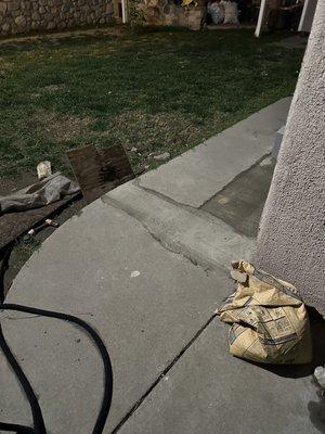 Patch-Up work. They even left a bag of cement. To the right of that bag are the trash cans they could have used.