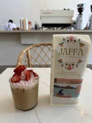 Seasonal mocktail - strawberry sage creek - and roasted coffee beans that say "everyone has the right to return to a cup of Jaffa"