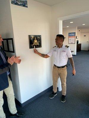 CAU San Diego flight student ringing the bell after achieving a flight milestone