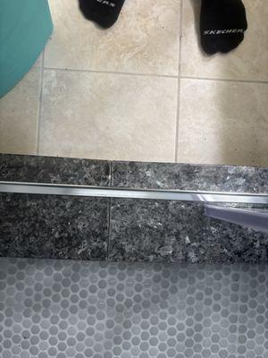 Silicone filling in shower bathrooms door step only