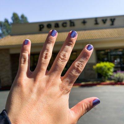 Manicure. Metallic purple polish.