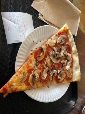 Cheese slice with added mushrooms and pepperoni