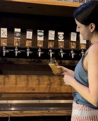 One of our beer specialists pouring one of 24 Beers on Draft.