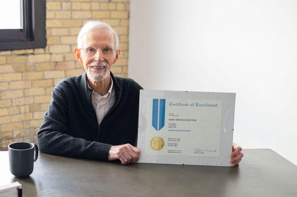 John Stevens, EA showing his Certificate of Enrollment to represent taxpayers before IRS